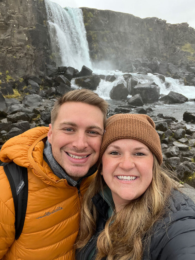 Jenna and her husband in front of a waterfall
